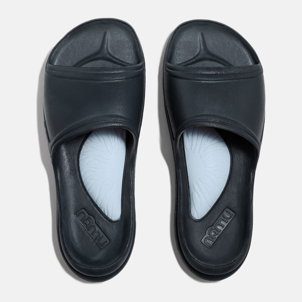 Pair of black slides with light blue insoles on a white background