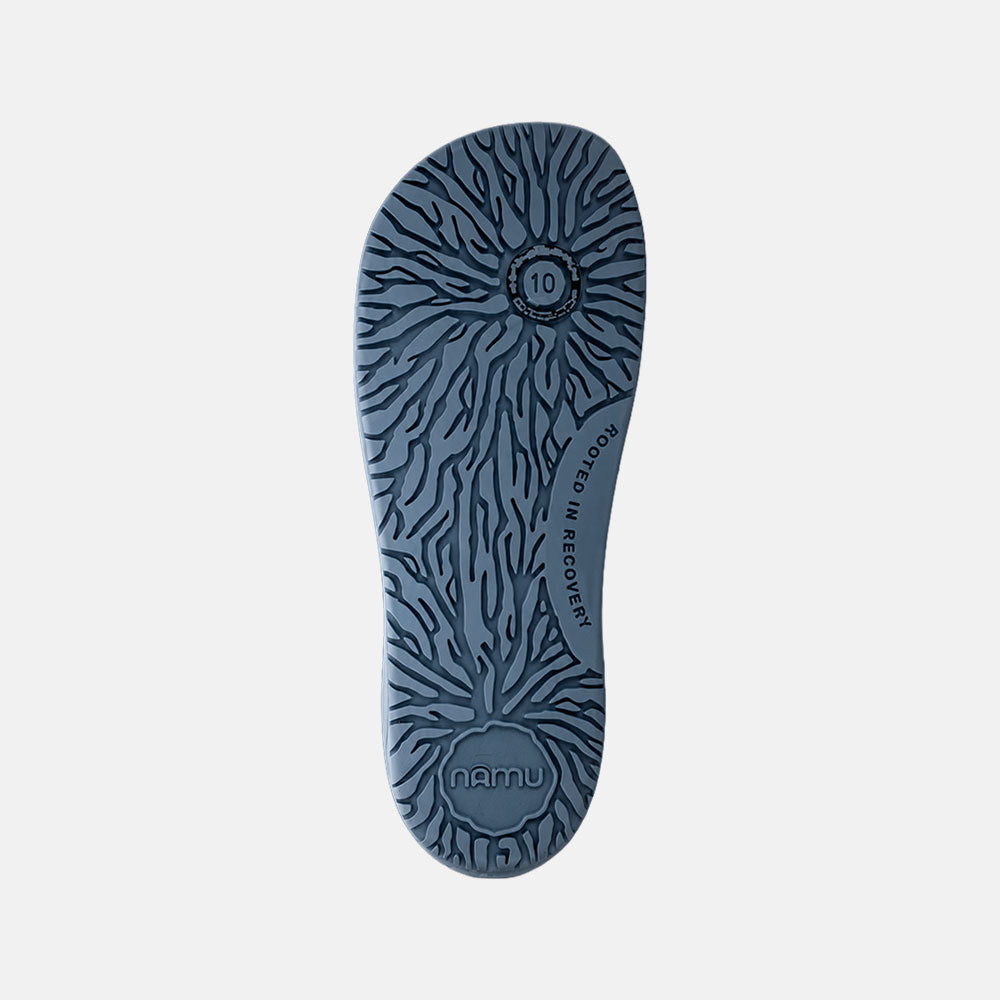 Blue shoe sole with textured pattern on a light gray background
