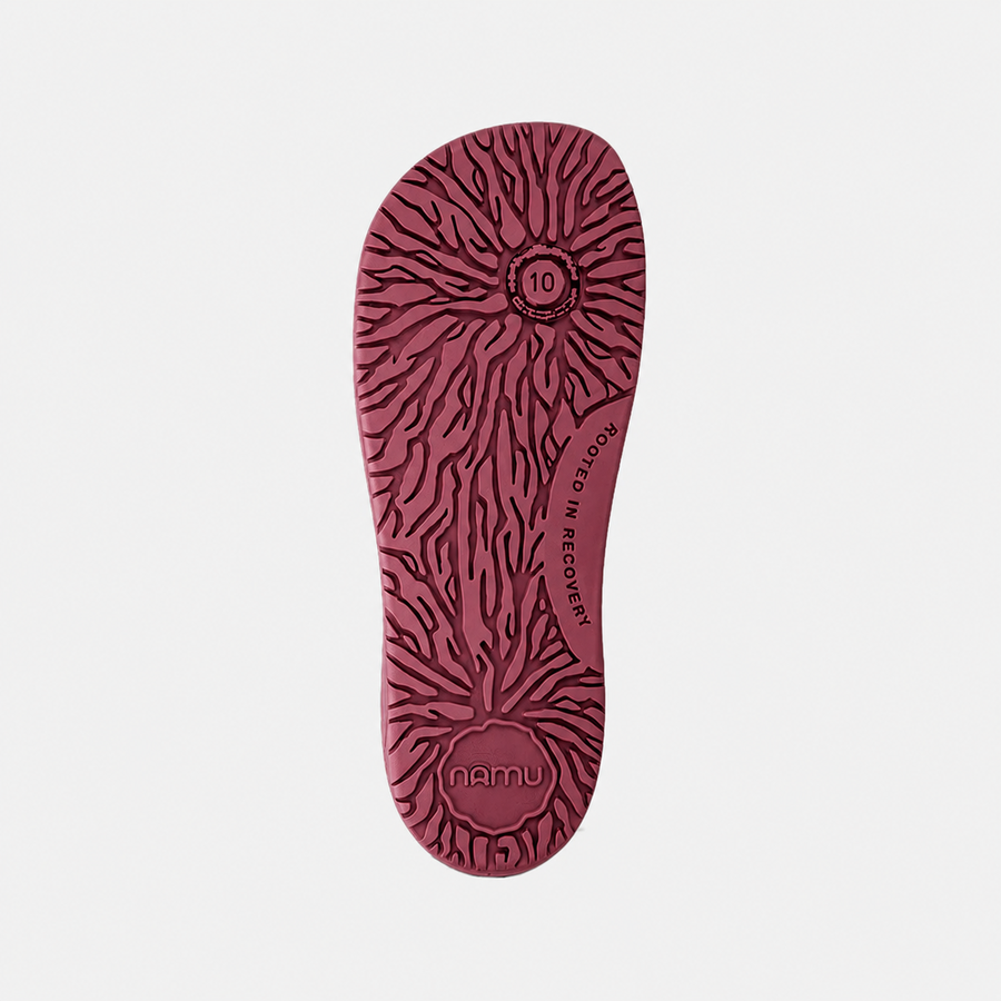 Red shoe sole with pattern and 'namu' branding on a light gray background